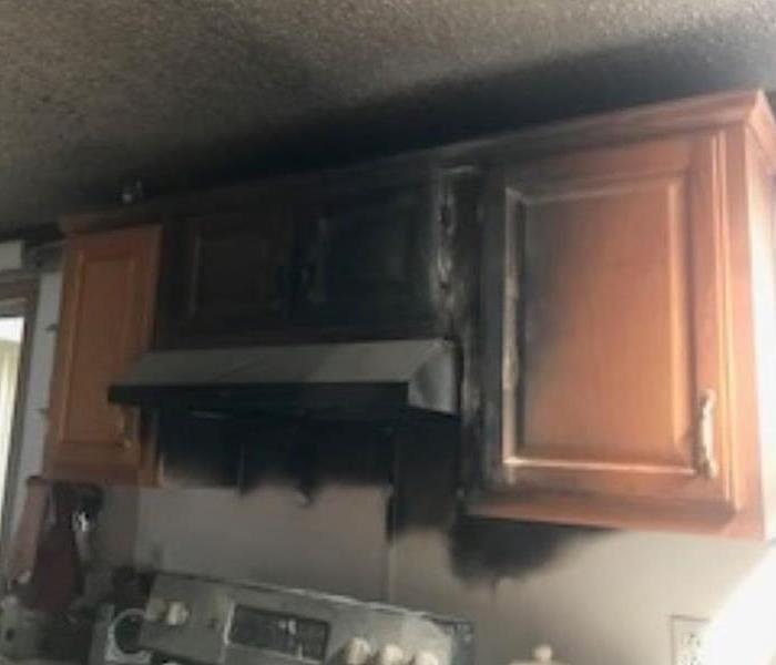 Stark County kitchen with severe fire damage to stove range hood and 3 upper kitchen cabinets