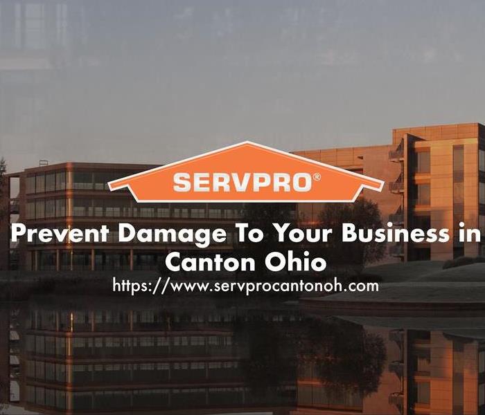 Orange SERVPRO  house logo on image with  commercial buildings in background 