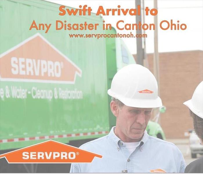 A man of authority standing in front of a SERVPRO Semi Truck wearing a hard hat ready to begin emergency services.